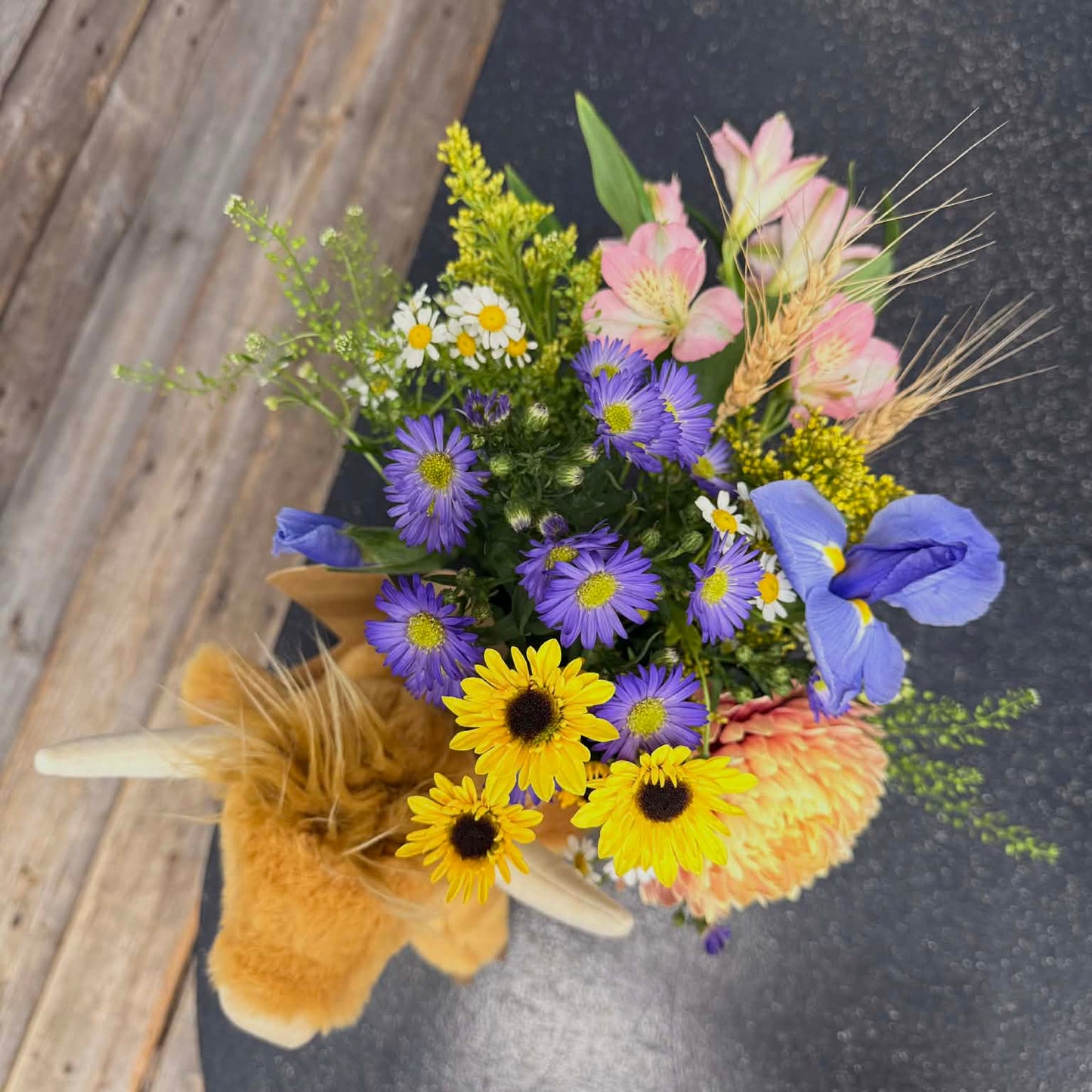 Colorful bouquet of flowers on a wooden surface