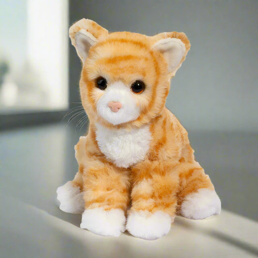 Plush toy cat with orange and white fur on a white background