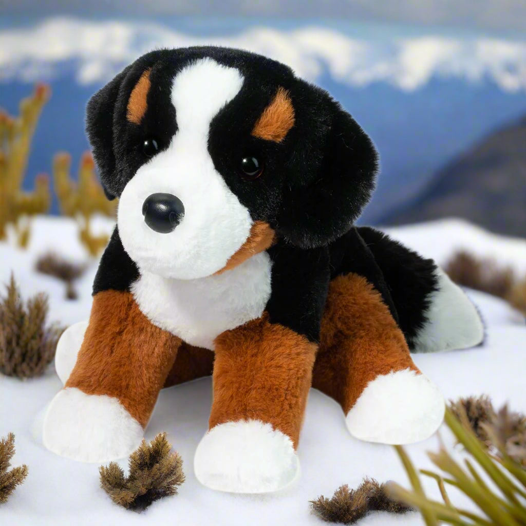 Plush toy dog with black, brown, and white fur on a white background