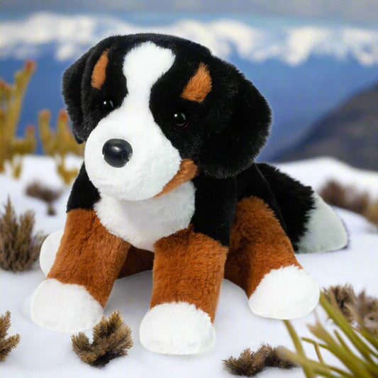 Plush toy dog with black, brown, and white fur on a white background