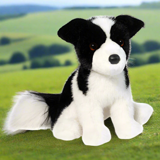Plush toy dog with black and white fur on a white background