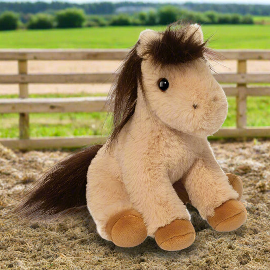 Plush toy horse with brown mane and feet on a white background
