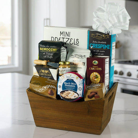 Gift basket with various snacks and treats in a wooden box on a white background