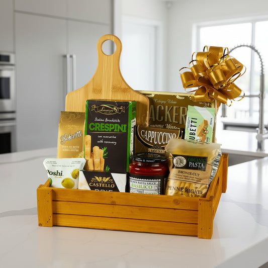 Gift basket with wooden cutting board, pasta, and other food items on a white background