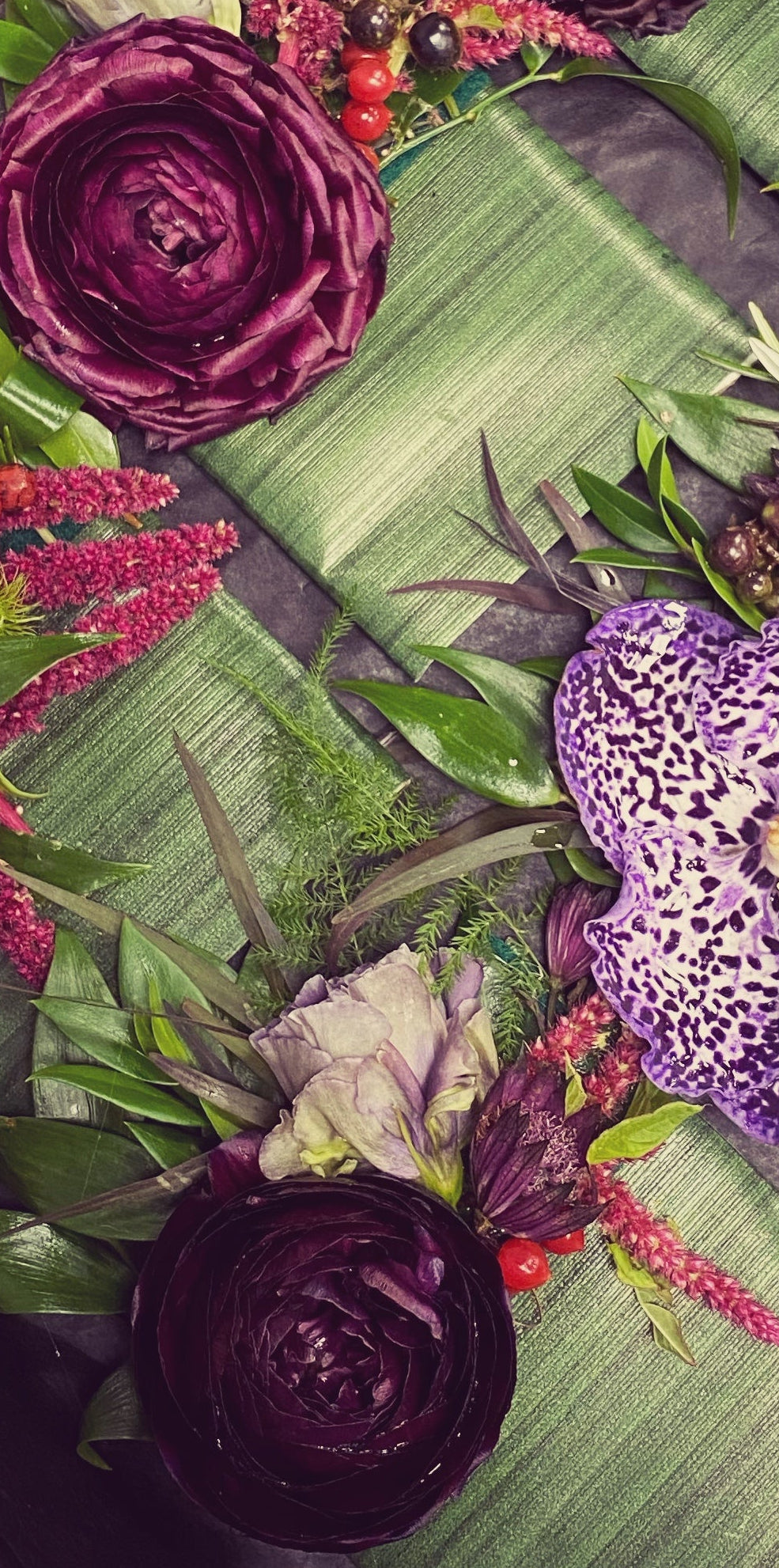 Decorative flowers in a box on a dark surface