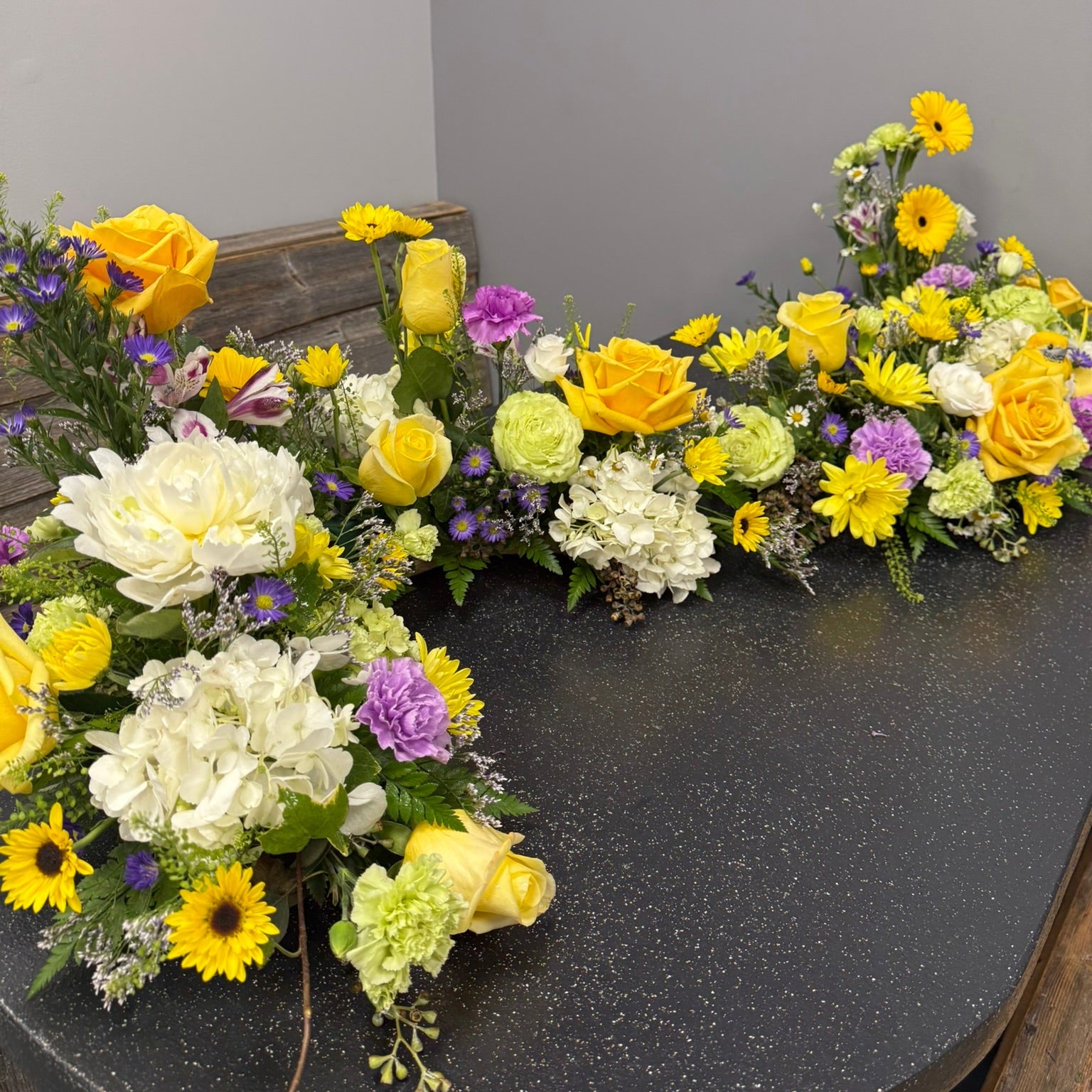 Floral arrangement on a table with a gray background